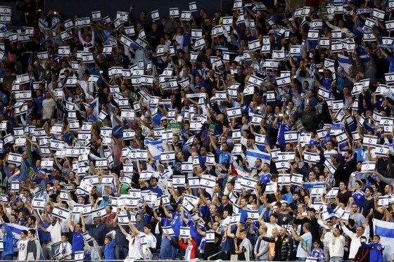 Israel fans hold placards during their Euro 2016 Group B qualifying soccer match against Wales at the Sammy Ofer Stadium in Haifa