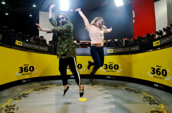 Las Vegas, Nevada. Jan. 5, 2015. Co-workers Donatella Caggiano, left, and Cheri Quigley, jump as 48 Nikon D750 cameras capture them in the Nikon 360 degrees project inside the Las Vegas Convention Center at CES 2015. (Photo by: Pankaj Khadka/BUNS)